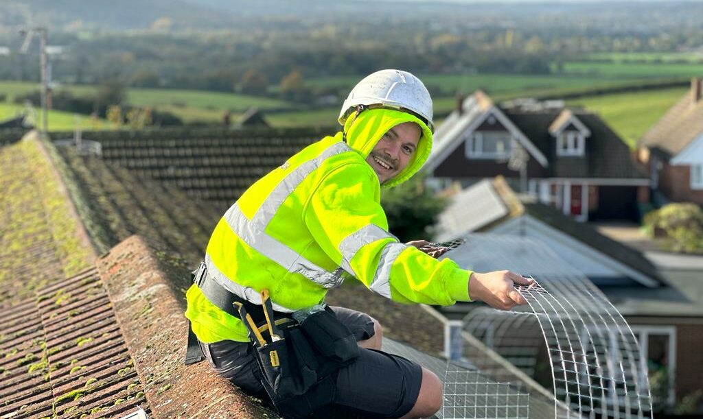 Integrum installing bird mesh to solar panels on domestic property