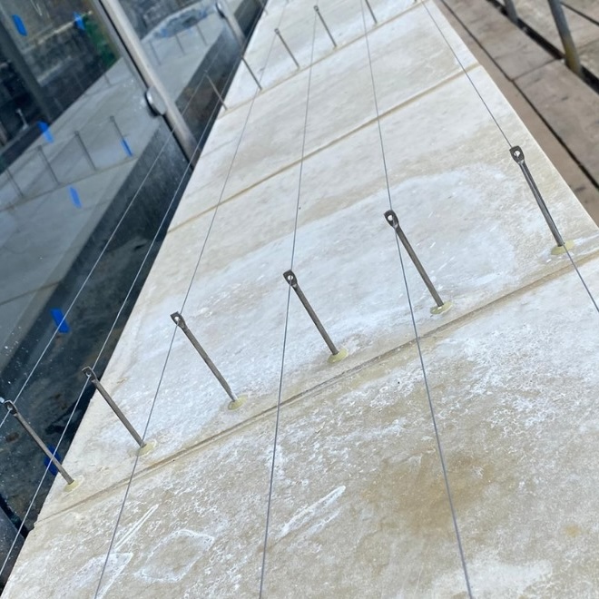 Bird deterrent wire and post system on a building